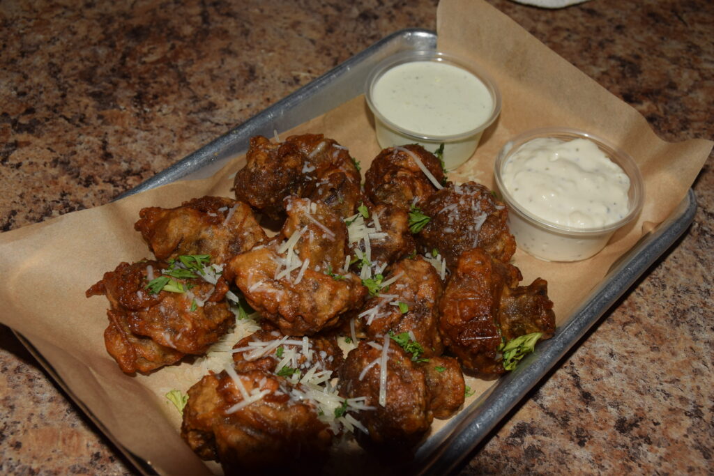 Boneless buffalo wings served with ranch and bleu cheese dressing